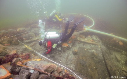 Underwater excavation of the galley area, indicated by brick stones during a field school.