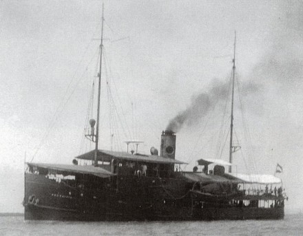 A black and white photo of the minelayer with two masts and steam cominf from its chimney.