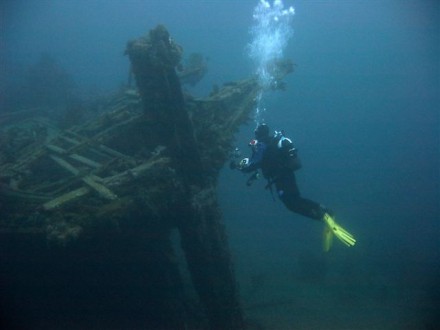 A photo of a diver inspecting the stern of the wreck.