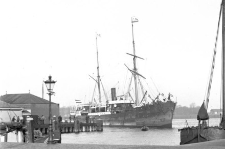 A black and white photo of the ship in a port.