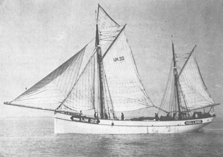 A black and white photo of a lugger under sail.