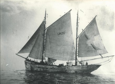 A black and white photo of the ship under sail.