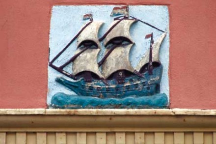 A colored gable stone showing a three masted ship.
