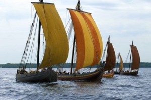 a photo of reconstructions of various types of longboats made by the Vikingeskibsmuseet in Roskilde sailing together. - Go to Nordic ship building tradition